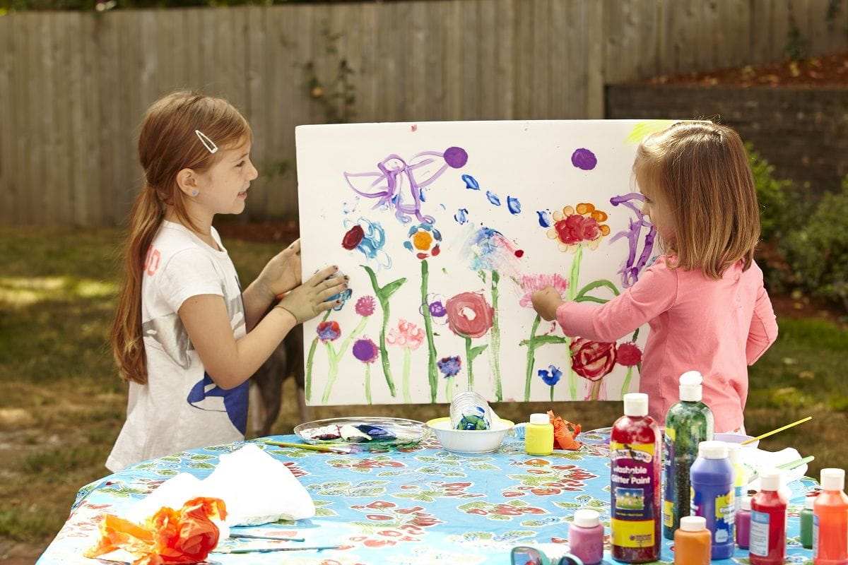 two girls painting roses